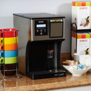 Lifestyle image of the Quench 166 pod coffee brewer on a countertop with break room supplies