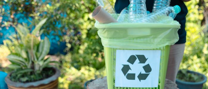recycling plastic bottles in a recycle bin