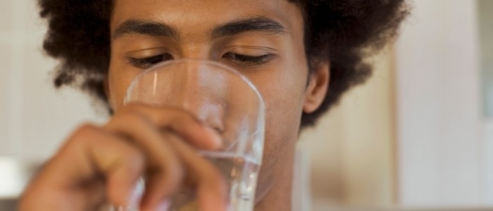 A gentleman drinking a glass of water