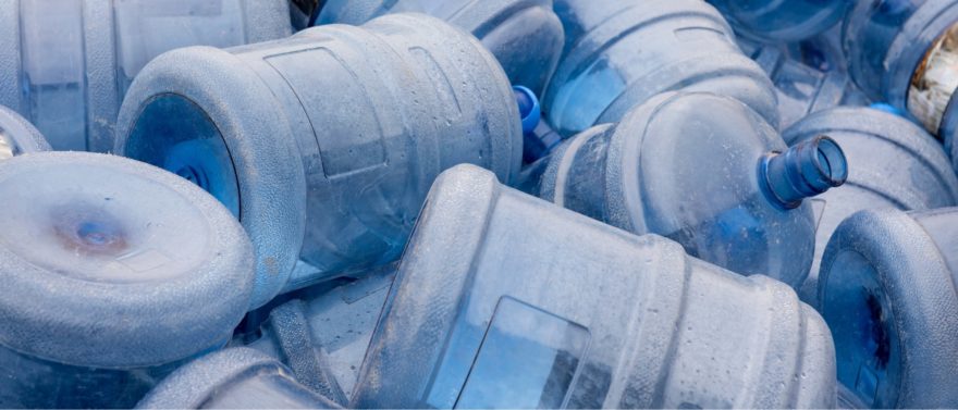 Pile of 5-gallon plastic jugs