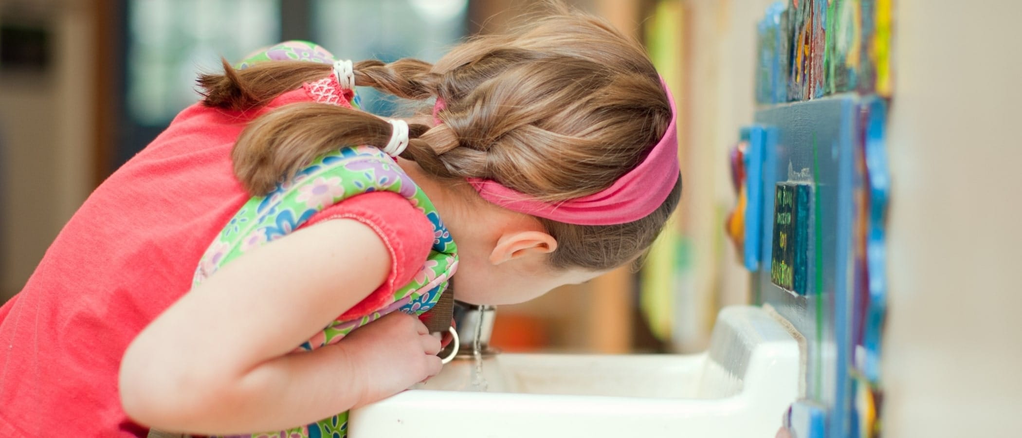 Girl Drinking From School Water Fountain