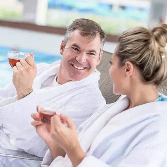 A man and a woman relaxing at the spa