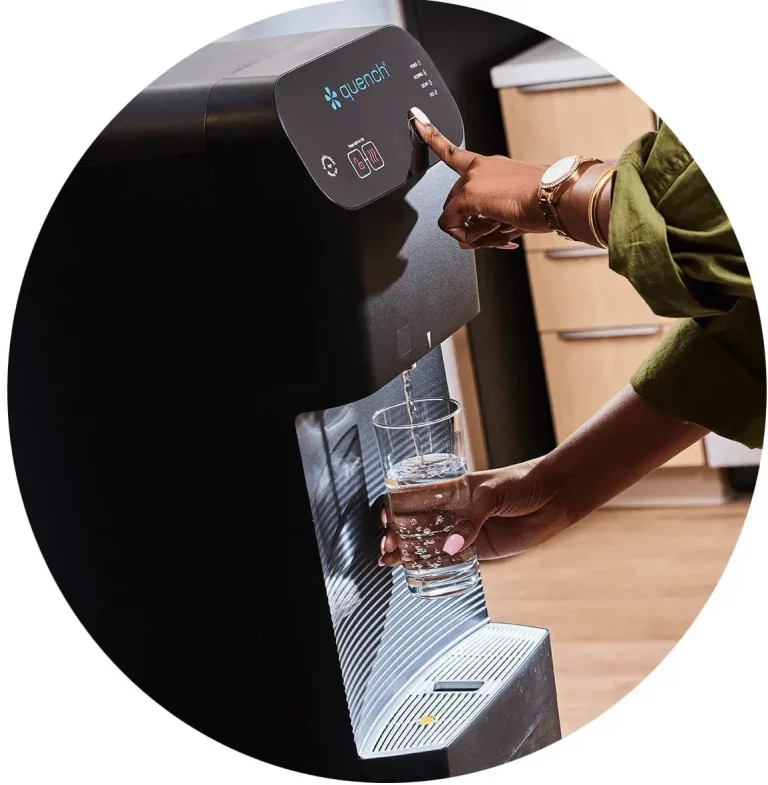 A woman dispensing filtered water from the Quench Q7 water cooler