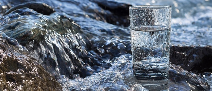 glass of water by the rocks