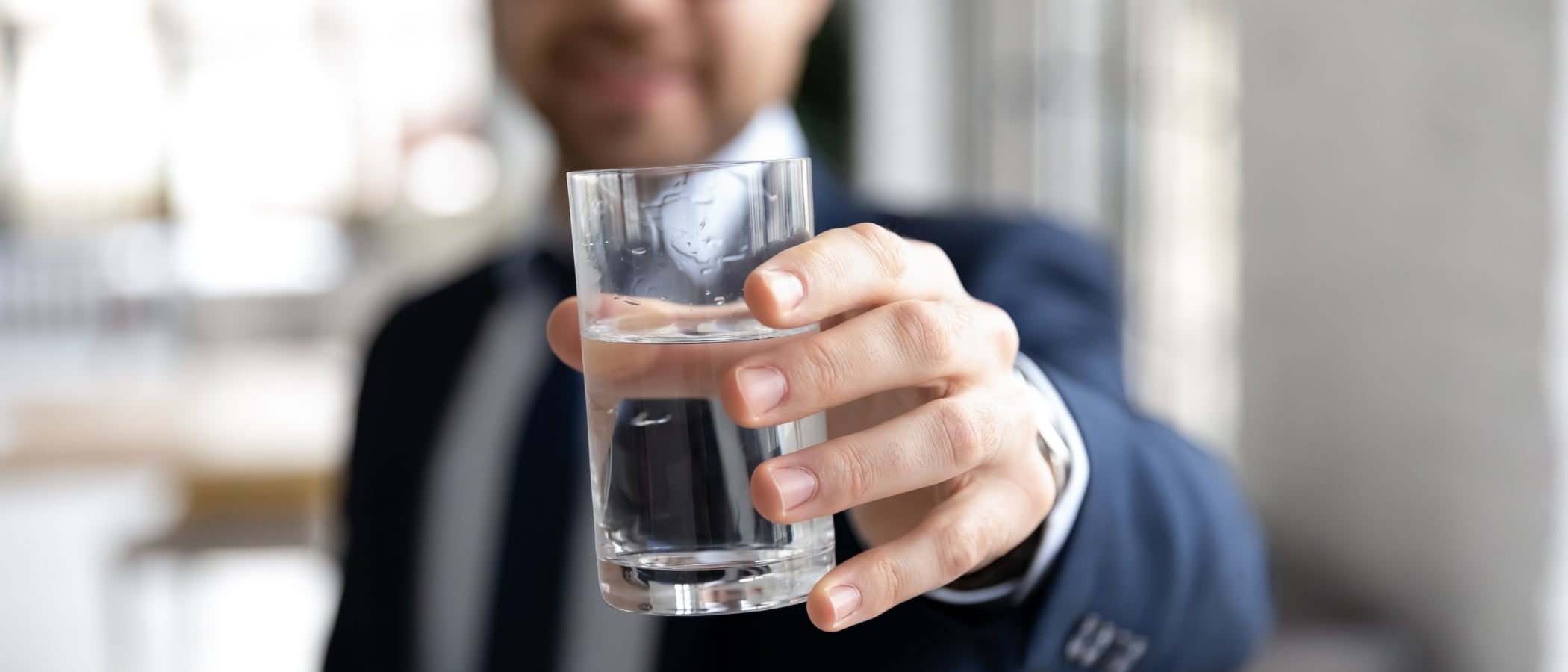 man holding glass of water