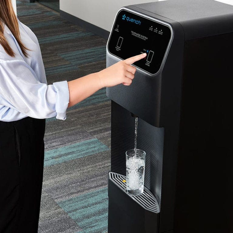 woman dispensing Q12 water dispenser