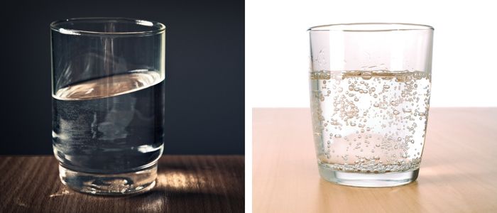 glass of still water next to glass of sparkling water