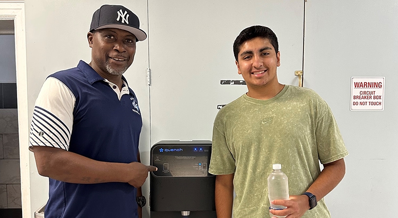 Om Sanan with Basket Ball Coach in front of Q12 water cooler