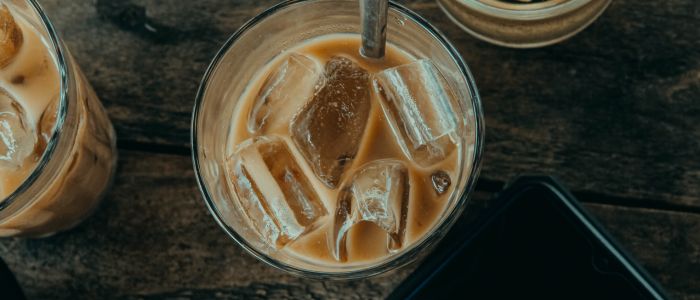 glass with iced coffee and spoon