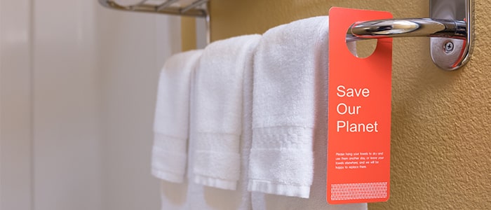 Towels hanging up with a save our planet sign