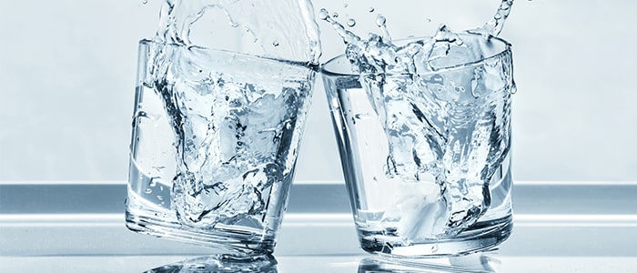 Two glasses of water cheersing