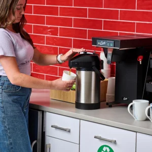 Woman dispensing coffee from Quench 154 thermal coffee brewer
