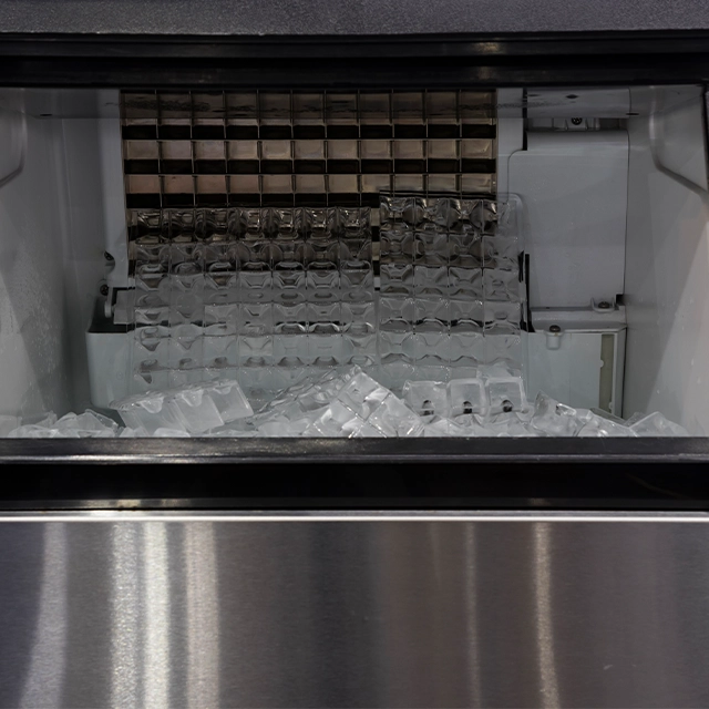 an open bin ice machine producing ice